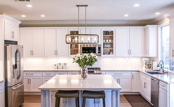 Vibrant white painted kitchen and island