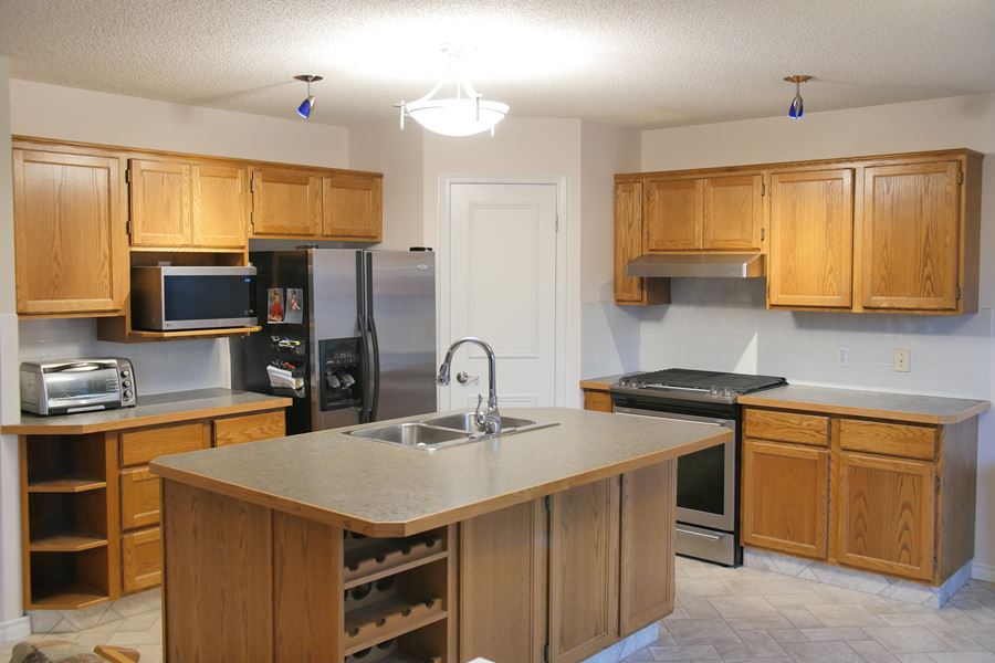 Yellow oak kitchen before painting Calgary