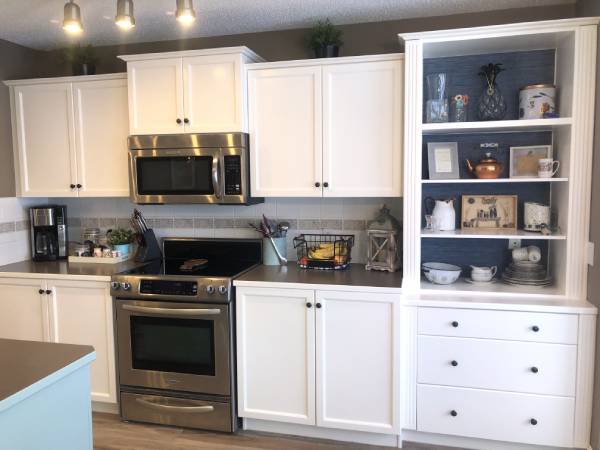 Modern white painted cabinetry featuring accent navy and white shelving