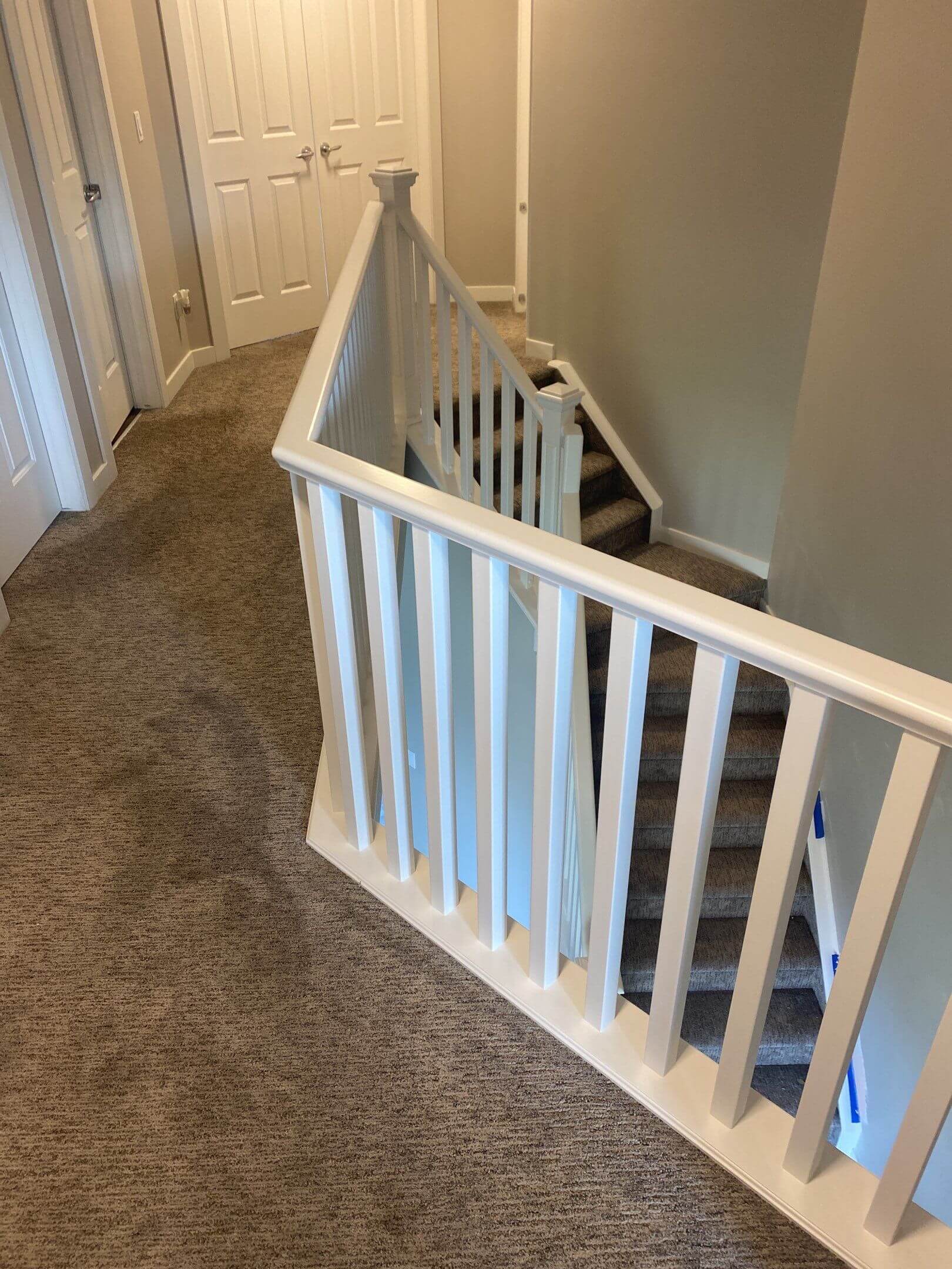 Modern white painted banister and upstairs trim Okotoks