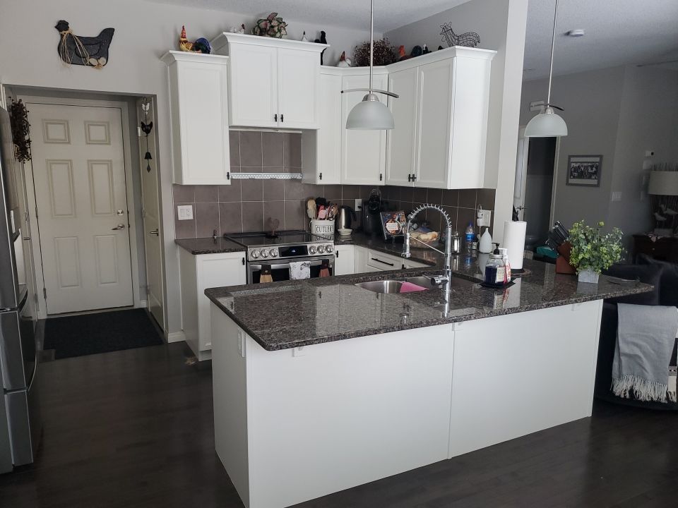 Dark Cabinets Repainted Off White after 2